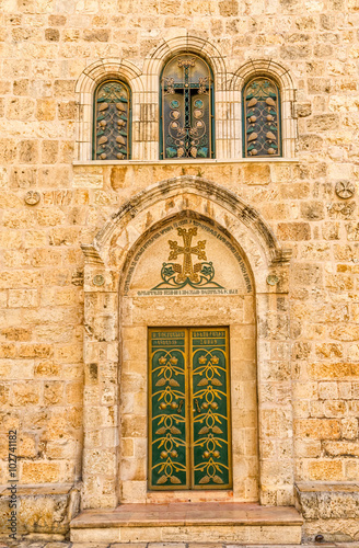Church of the Holy Sepulchre detail green door and three windows  holiest Christian site in the world.