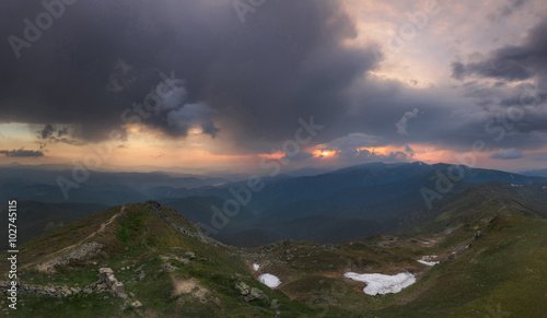 Carpathian Mountains. Panorama. Clouds with sunset light.