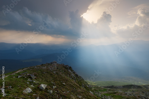 Carpathian Mountains. The rays breaking through the clouds illuminating the ground © naumenkophoto