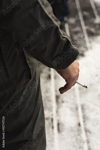 hand holding a smoking cigarette