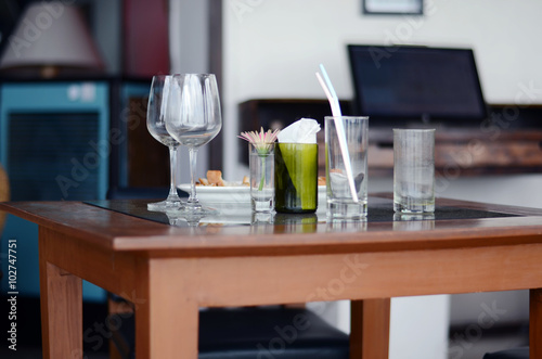Empty wine glasses on wooden table © hemantrohan