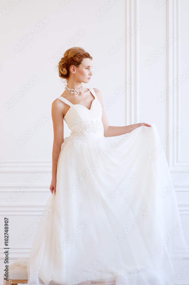 Young adult caucasian blond bride in white gown Young adult caucasian blond bride in white gown