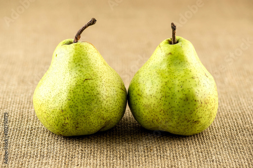 Succulent juicy pears against hessian textured cloth
