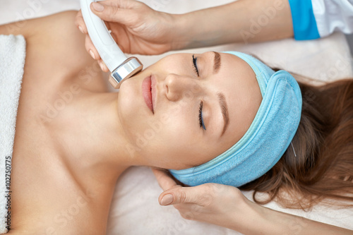 ultrasonic face cleaning, peeling, in a beauty salon photo