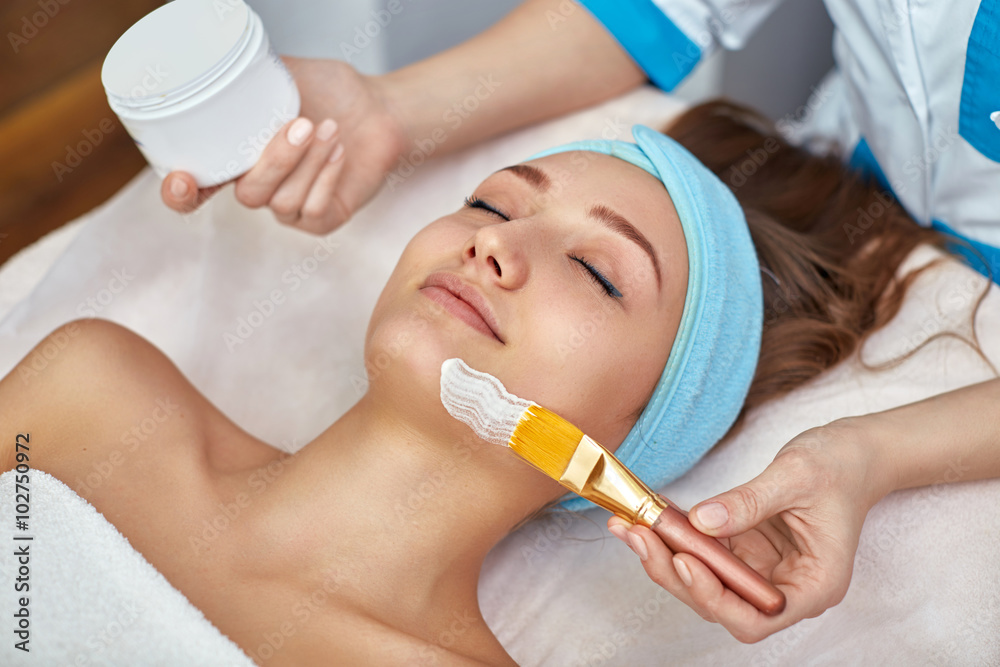 applying facial mask in a beauty salon