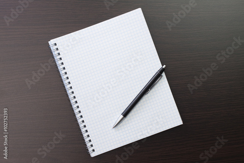 blank notebook and pen on the table © Ruslan Grumble