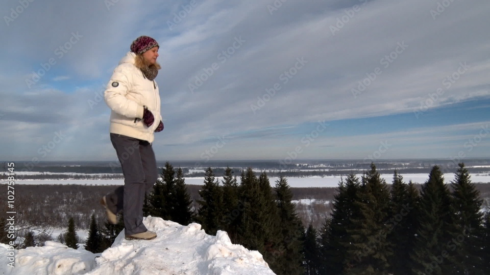 Woman on Mountain in Winter / Woman in warm clothing rises on a hill of snow and stands on a background of nature
Woman on Mountain in Winter / Woman in warm clothing rises on a hill of snow and stands on a background of nature