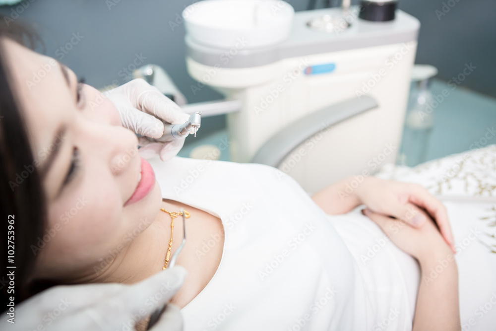 Dentist examining a patient's teeth in the dentist. Dentist examining a patient's teeth in the dentist.