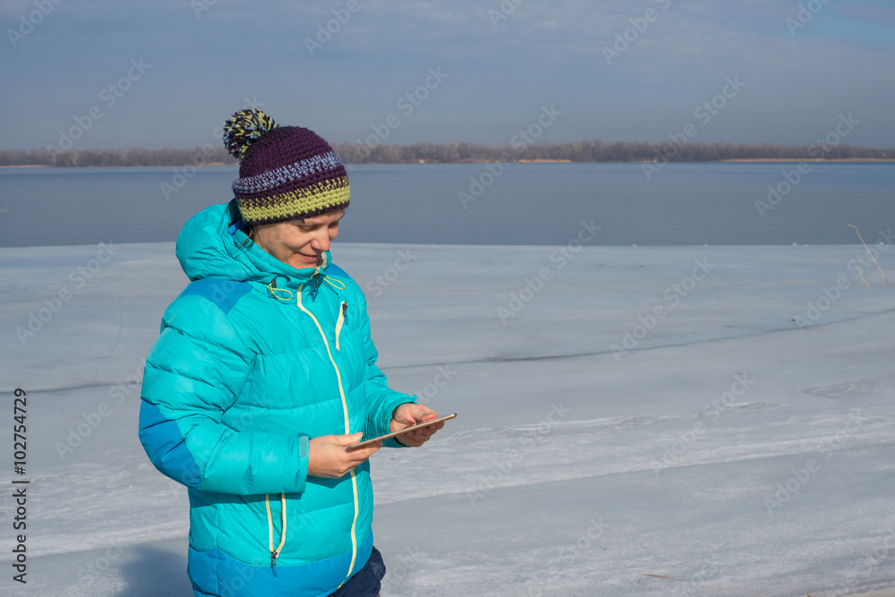 Smiling woman uses a tablet pc for communication Smiling woman uses a tablet pc for communication