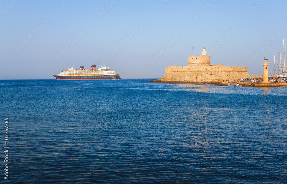 Cruise ship on the background of the fortress of St. Nicholas. Rhodes Island. Greece