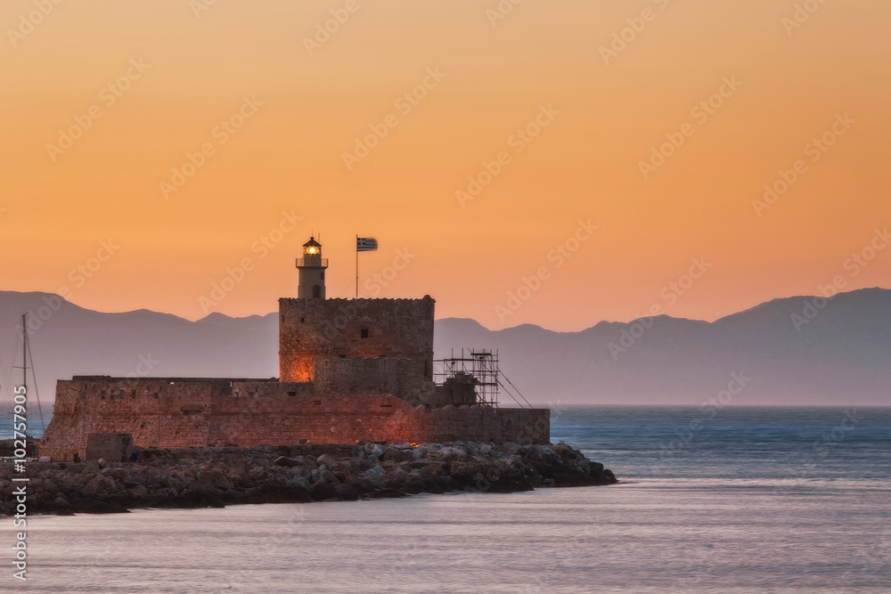 St. Nicholas Fortress and lighthouse at sunset. Rhodes Island. Greece