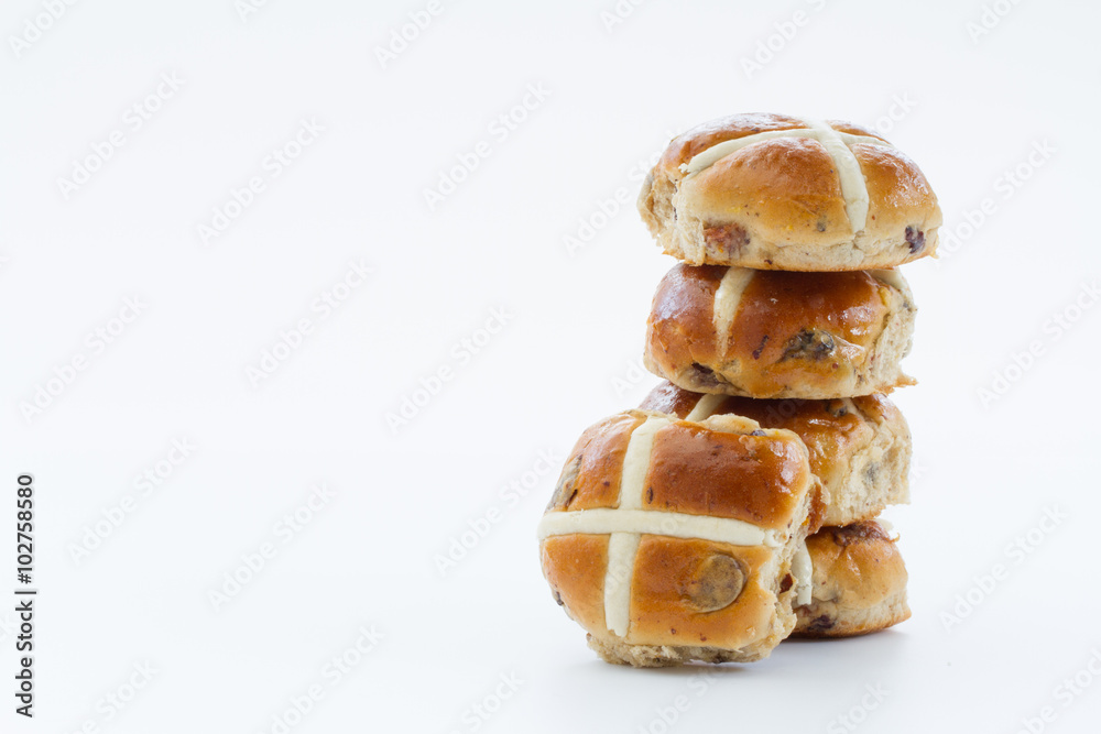 Easter hit cross buns stacked up on an isolated white background.