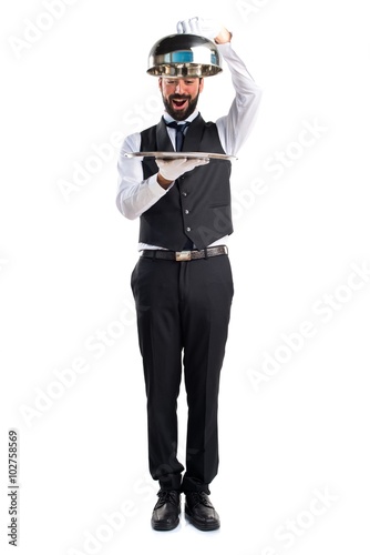 Luxury waiter holding a tray © luismolinero