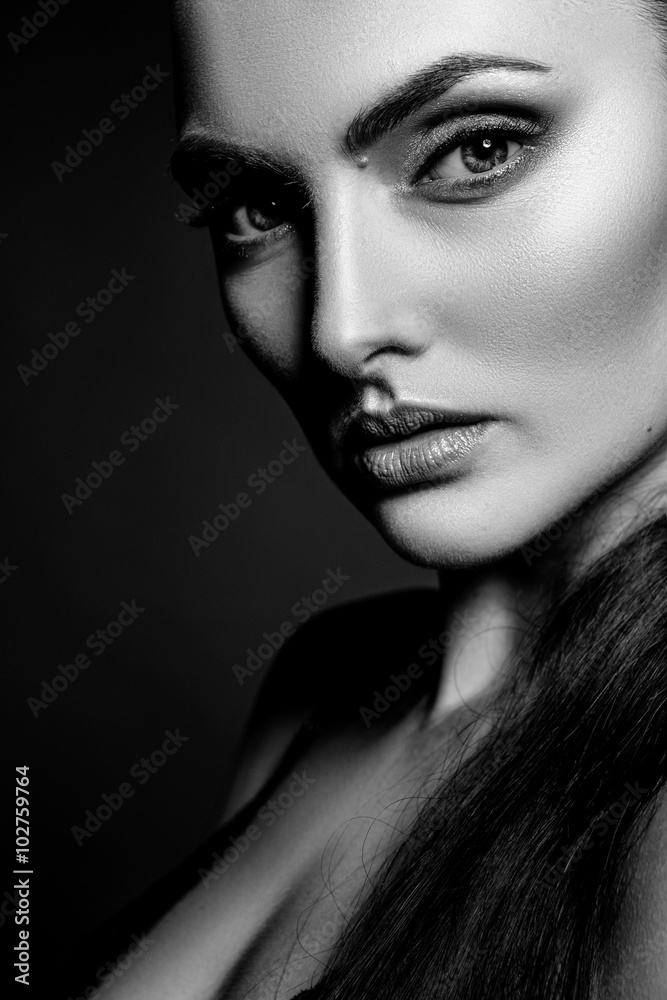 Elegant beautiful girl model with hair gathered in a ponytail. Black and white art photo.