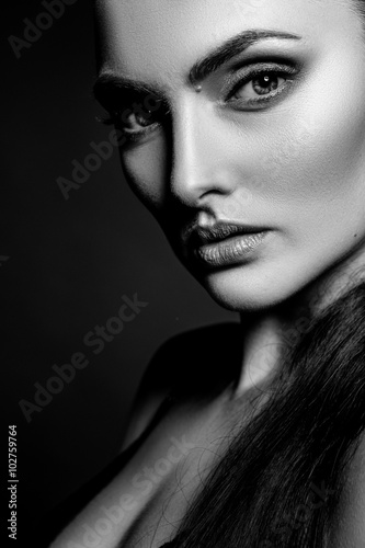 Elegant beautiful girl model with hair gathered in a ponytail. Black and white art photo.