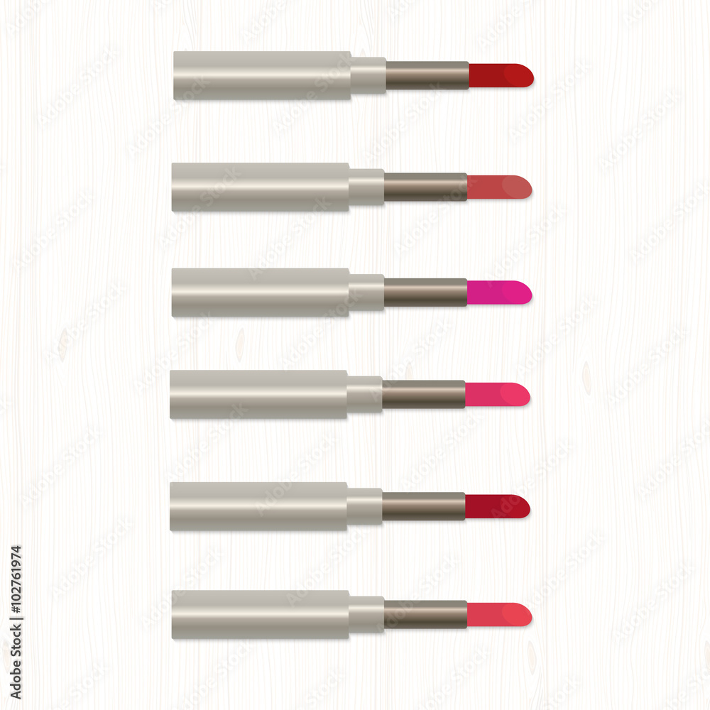 Set of realistic colored lipsticks on white wooden table