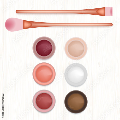 Set of colored blushers and brushes on white wooden table