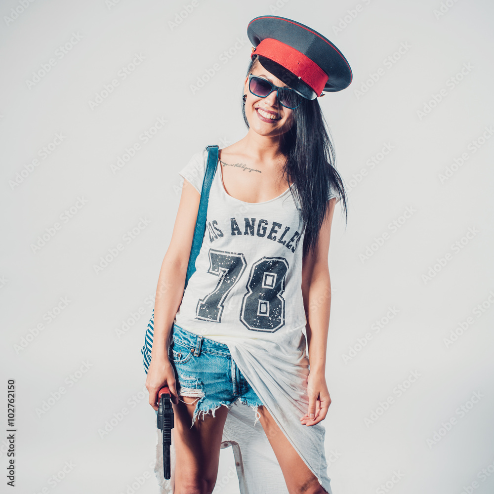 Fashion swag sexy girl holding gun woman having fun wearing police cap. Fashion swag sexy girl holding gun woman having fun wearing police cap.