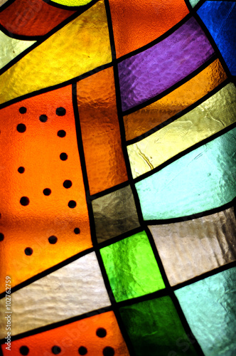 Image of a multicolored stained glass window with irregular bloc