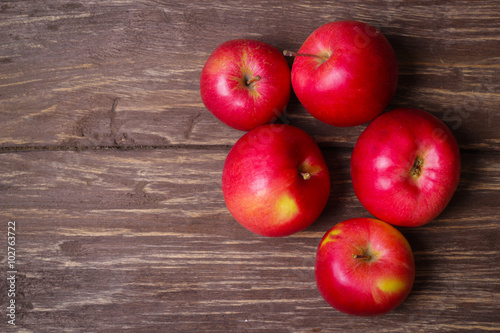 Fresh beautiful red apples on a wooden background