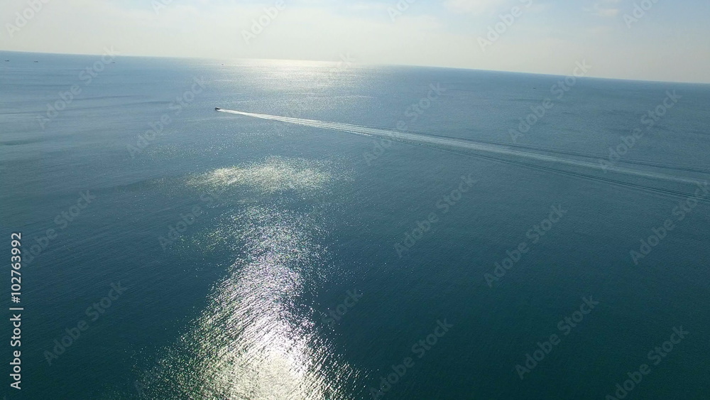 aerial view of speed boat running over blue ocean aerial view of speed boat running over blue ocean