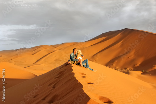 Loving couple in the Sahara Desert