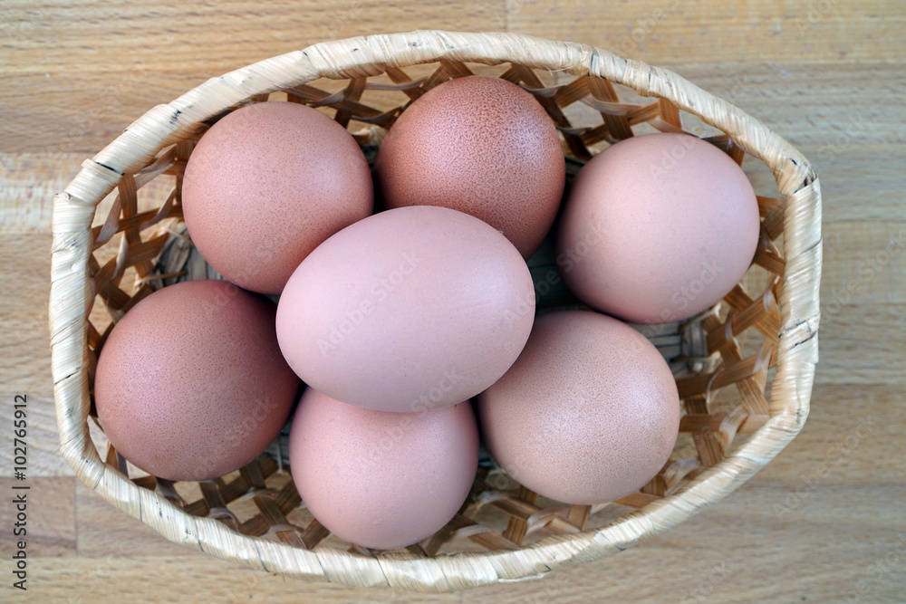 eggs lying in a wicker basket on the table eggs lying in a wicker basket on the table