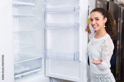 brunette choosing new refrigerator