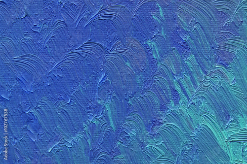 Colored brushstrokes of blue oil paint on canvas
