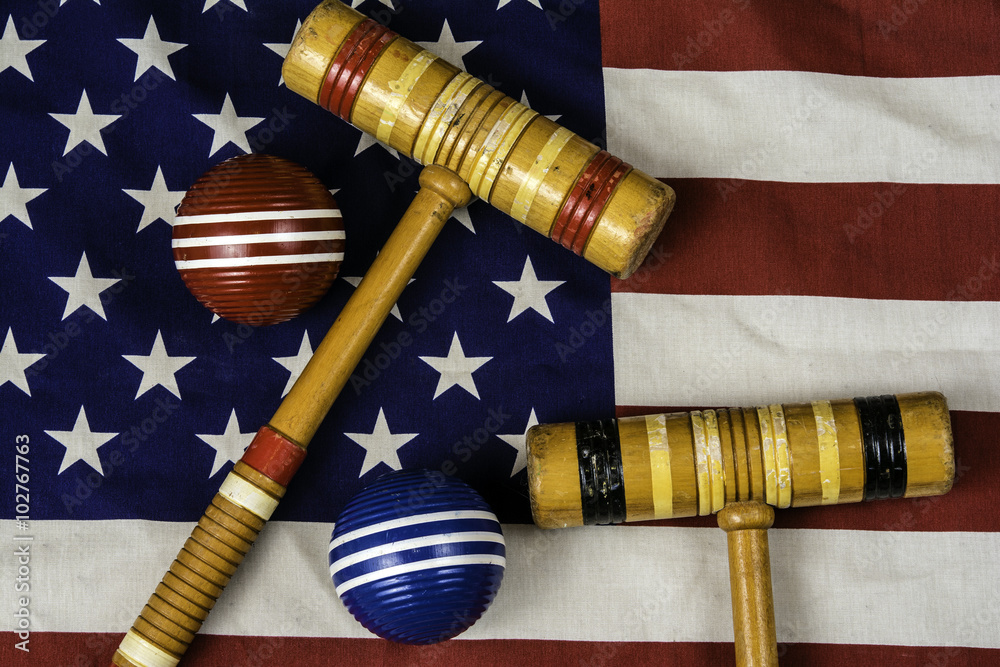 croquet mallets and balls on american flag