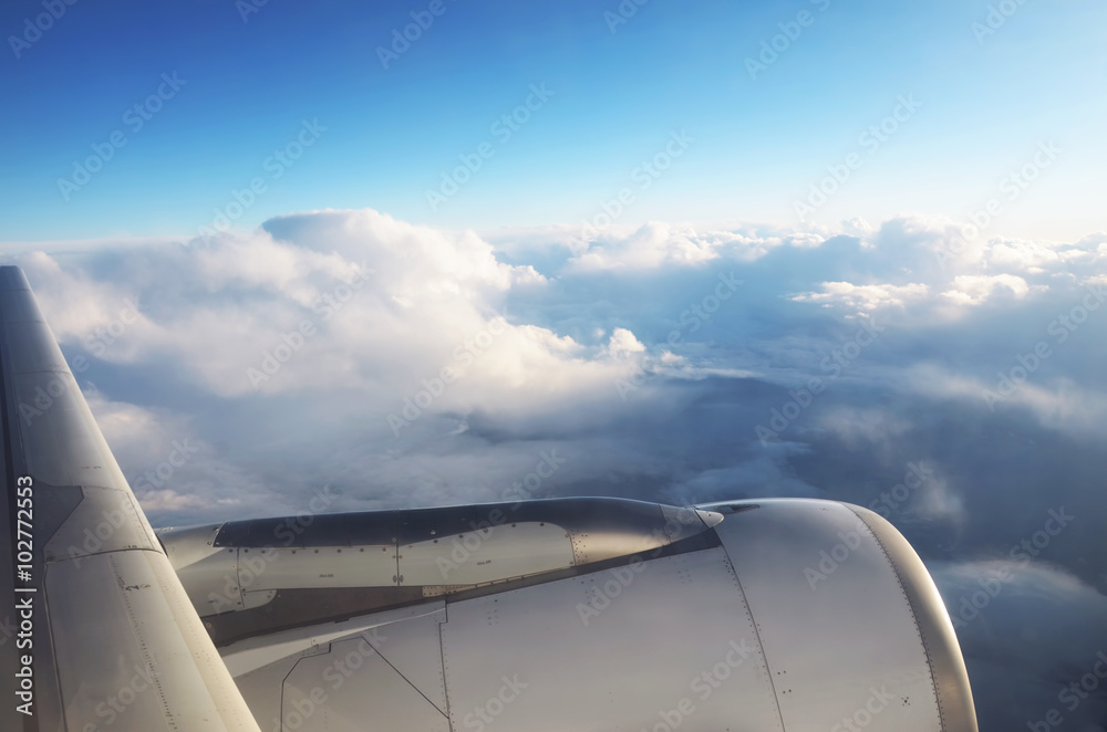 Clouds from the top and dramatic sunset, airplane view