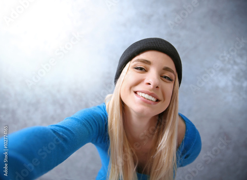 Young girl in black hat tak...