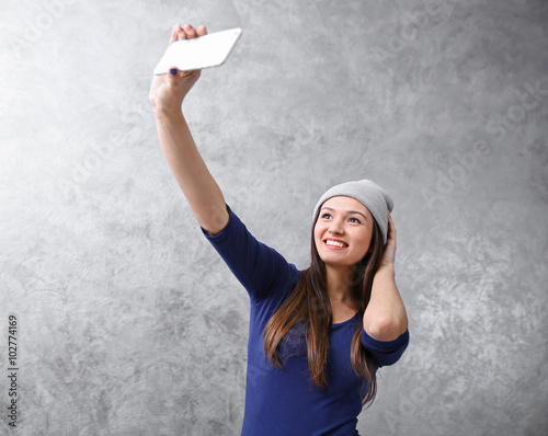 Young girl in hat taking ph...