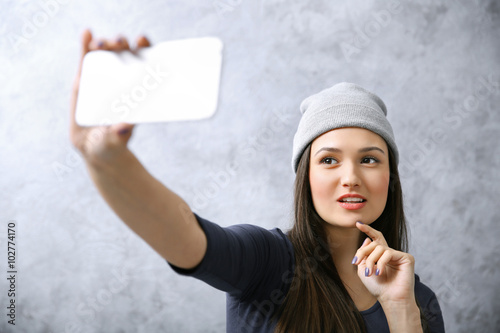Young girl in hat taking ph...