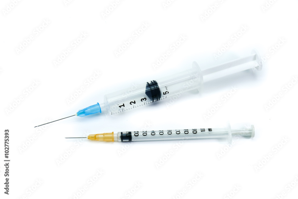 Two medical syringes, one big syringe with blue neddle and one small syringe with orange neddle, isolated on white background Two medical syringes, one big syringe with blue neddle and one small syringe with orange neddle, isolated on white background