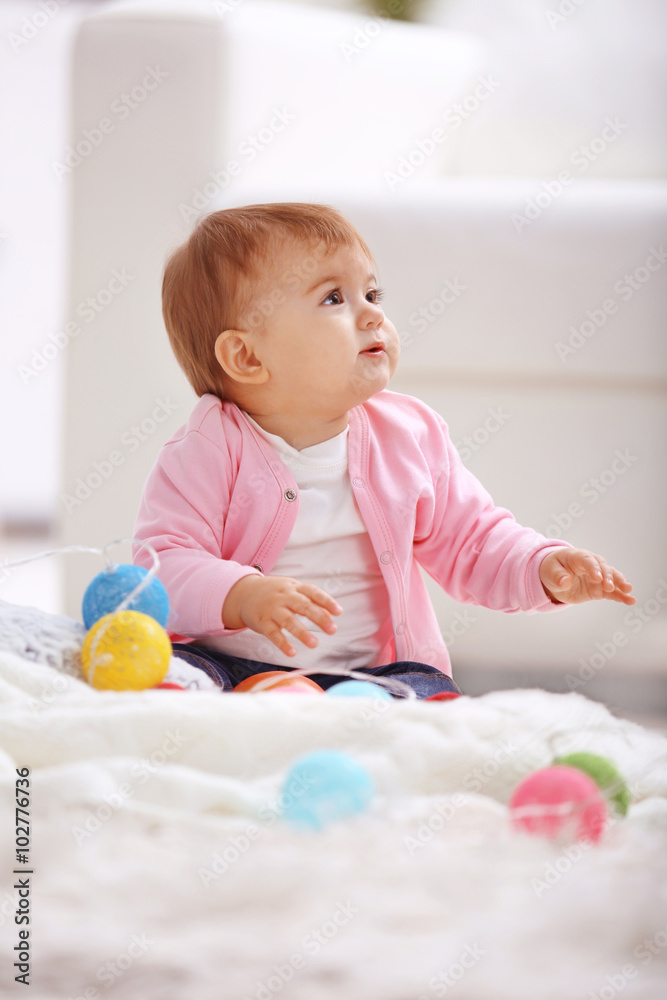 Sweet baby girl playing with colored balls Sweet baby girl playing with colored balls