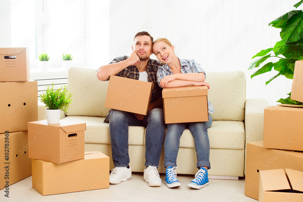 moving to a new apartment. Happy family couple and cardboard box moving to a new apartment. Happy family couple and cardboard box