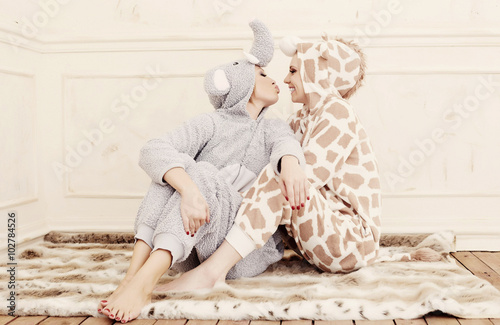Two women in pajamas.