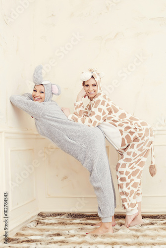 Two playful women in pajamas.