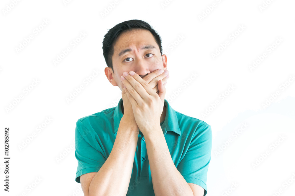Young Asian man covering his mouth with hands Young Asian man covering his mouth with hands