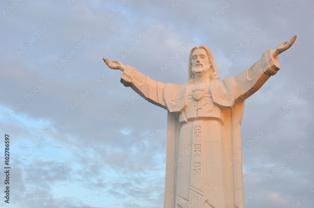 Statue of Jesus Christ with open arms at sunset Stock Photo | Adobe Stock