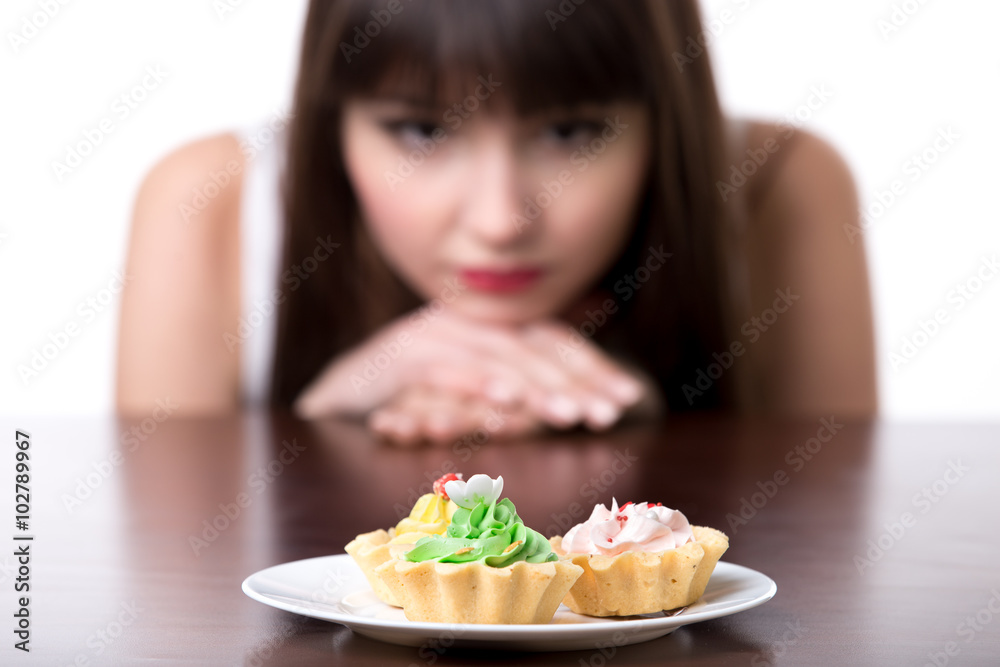 Dieting woman craving for cake Dieting woman craving for cake
