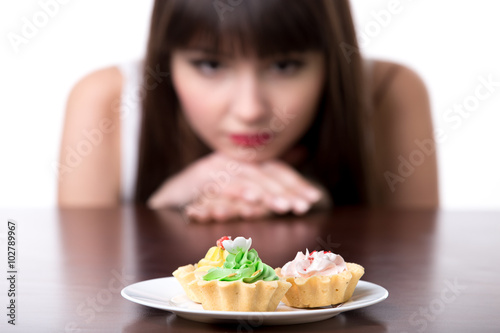 Dieting woman craving for cake
