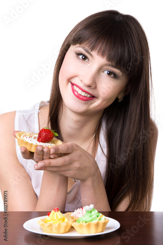 Young woman with plate of cakes