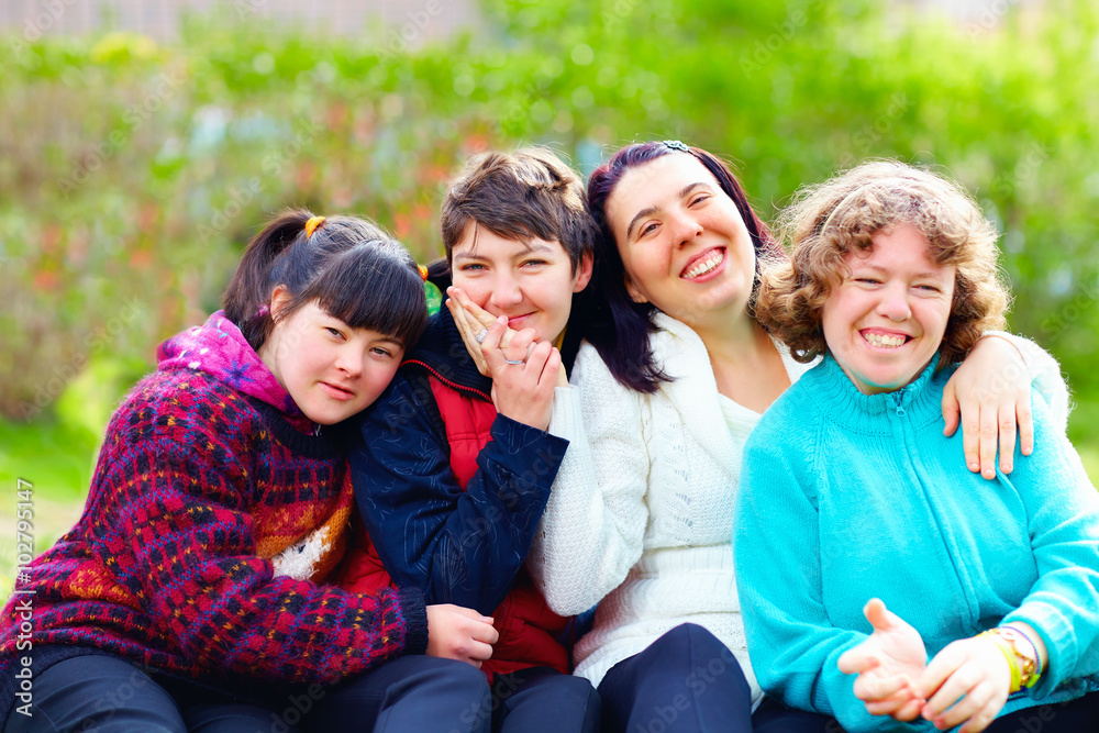 group of happy women with disability having fun in spring park