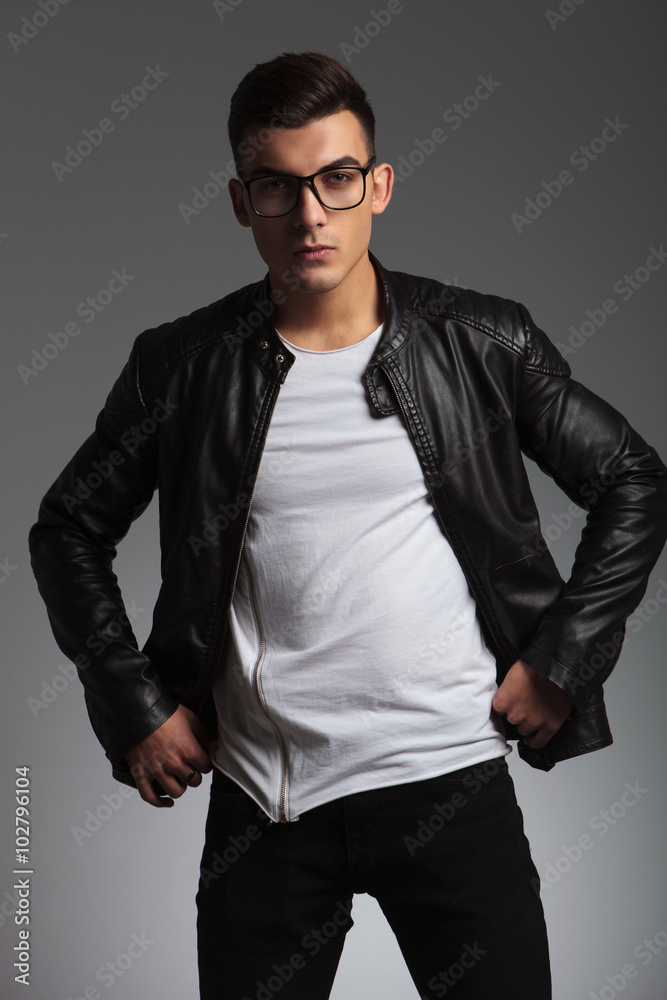 model wearing glasses in studio fixing his jacket model wearing glasses in studio fixing his jacket