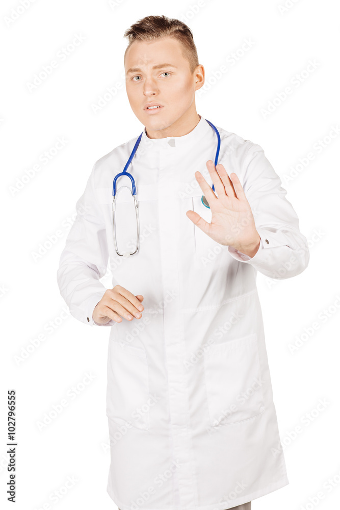 Young male doctor in white coat and stethoscope making stop sig Young male doctor in white coat and stethoscope making stop sig