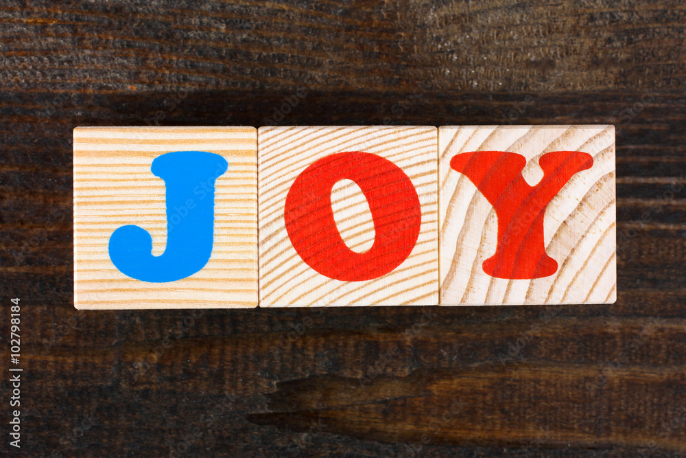 the word from children's wooden blocks with colorful letters on wooden table the word from children's wooden blocks with colorful letters on wooden table