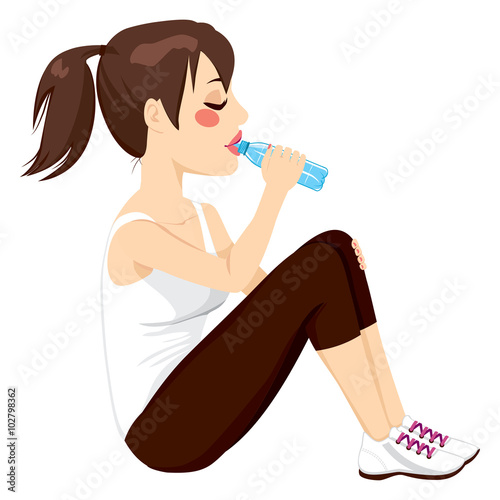 Beautiful brunette woman drinking a bottle of water while resting sitting