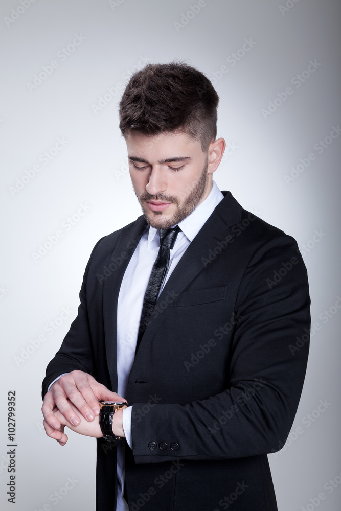 Businessmann im Anzug blickt auf Uhr Porträt Businessmann im Anzug blickt auf Uhr Porträt